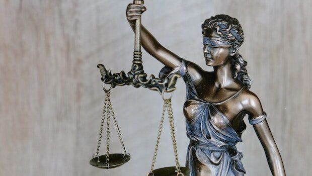 "Lady Justice" statue: blindfolded woman holding scales