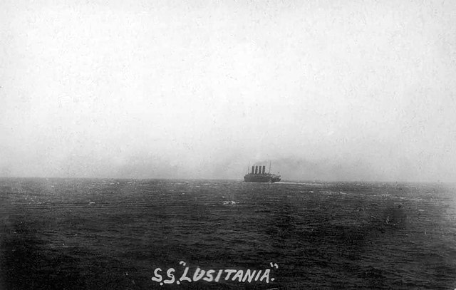 Black and white photo of a large ship in the distance. Handwritten caption says "S.S. Lusitania."