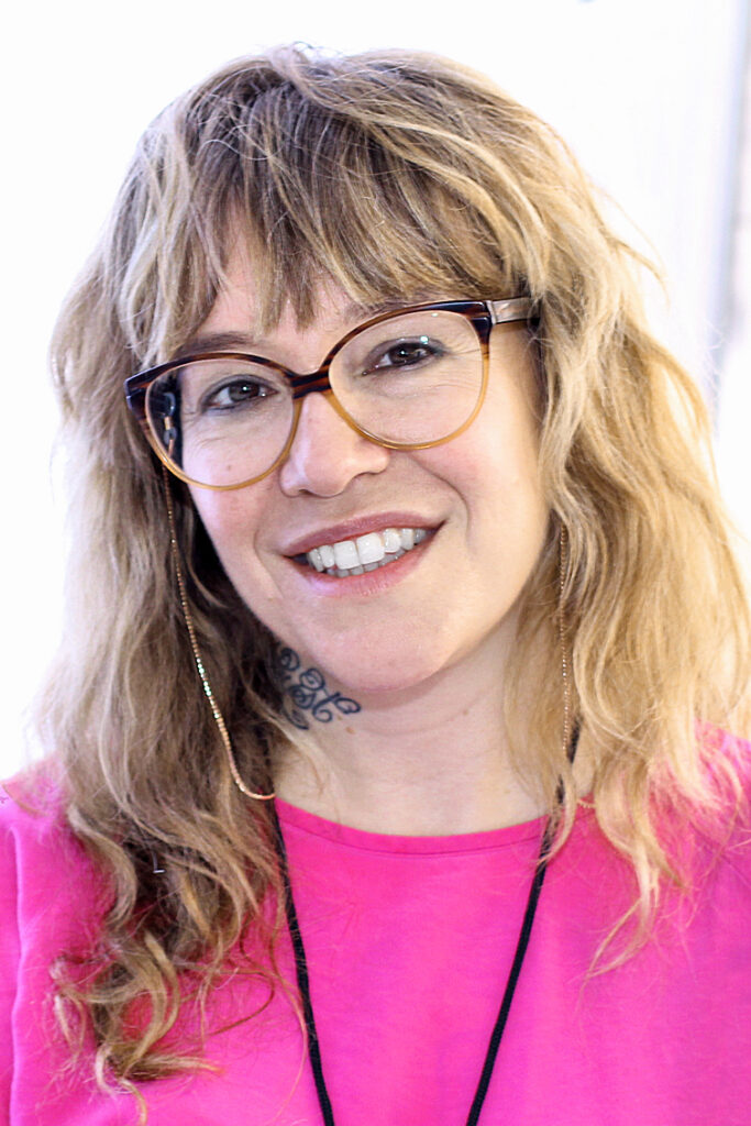 Headshot of Michelle Tea, a white woman with light brown hair, glasses, and a pink shirt