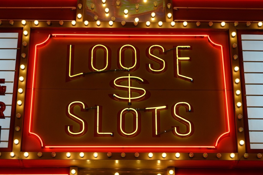 Neon sign that says "Loose Slots"
