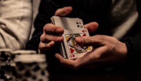 Hands holding a deck of cards