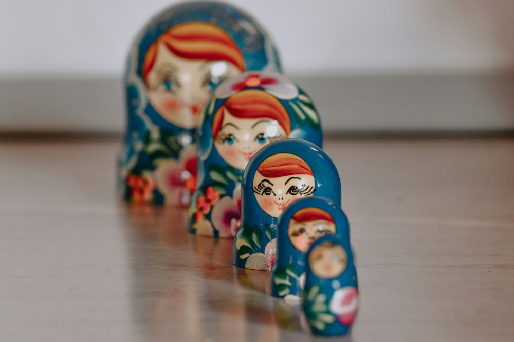A row of five blue Russian nesting dolls