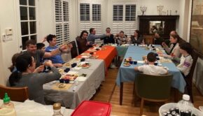 Family gathered at long tables for a bar mitzvah meal