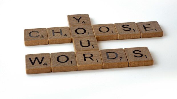 Scrabble tiles spelling out "Choose your words"