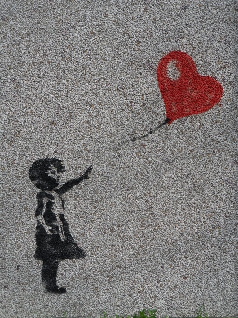 Stenciled paint on sidewalk depicts a little girl letting go of, or reaching for, a heart-shaped balloon
