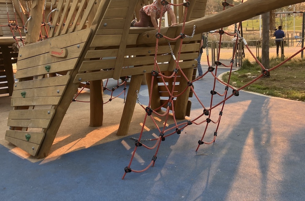 Park play structure shaped like a boat