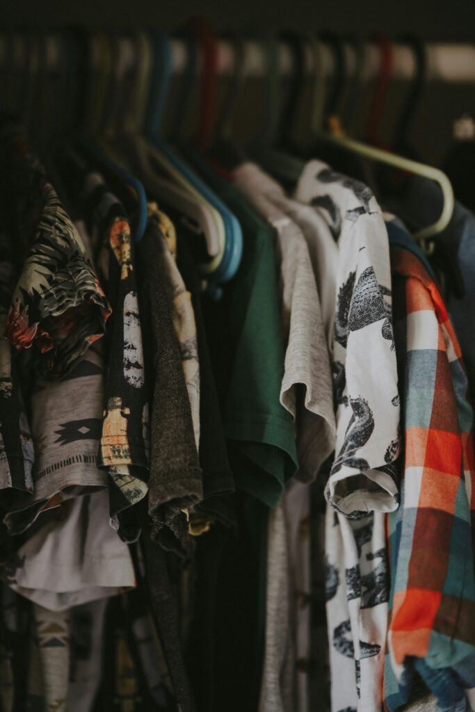 Colorful clothes hanging in a closet