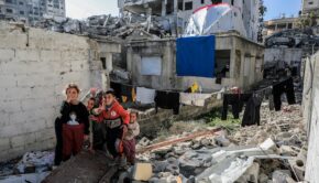 Smiling children amid rubble in Gaza