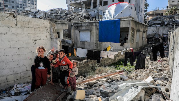 Smiling children amid rubble in Gaza