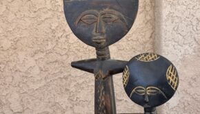 Wooden dolls from Ghana with thin bodies and big round heads