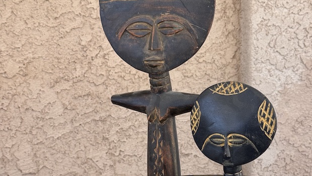 Wooden dolls from Ghana with thin bodies and big round heads