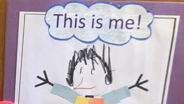 A child's drawing of a person with a bubble that says "This is me!"
